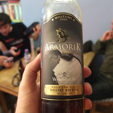 Holding a bottle of Amorik Millésime 2002